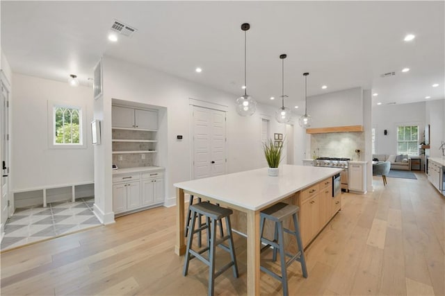 201 S Cortez St, New Orleans, LA 70119 - kitchen featuring backsplash, light wood-type flooring, light countertops, and recessed lighting