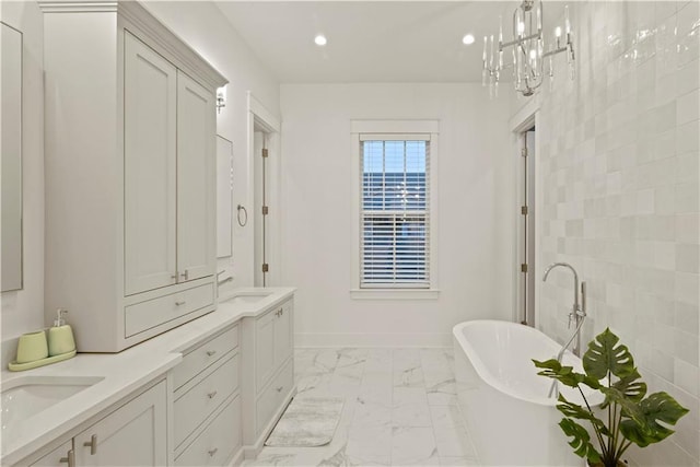 bathroom with a tub to relax in and vanity