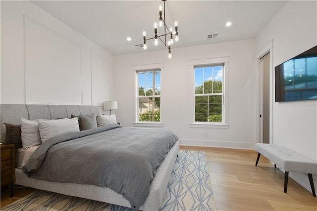 201 S Cortez St, New Orleans, LA 70119 - bedroom featuring light wood-style flooring, a chandelier, and recessed lighting