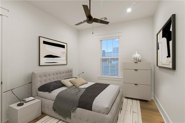 bedroom featuring ceiling fan and light hardwood / wood-style flooring