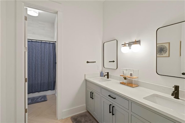 bathroom featuring parquet floors, walk in shower, and vanity