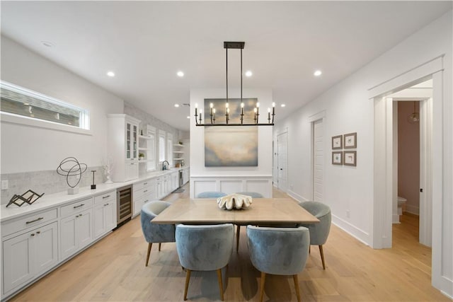 201 S Cortez St, New Orleans, LA 70119 - dining space with wine cooler, light wood-style flooring, a chandelier, recessed lighting, and bar area