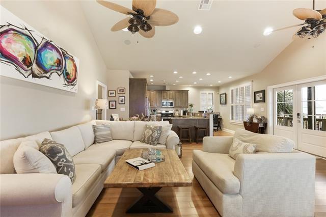 living room with vaulted ceiling, ceiling fan, light hardwood / wood-style floors, and french doors