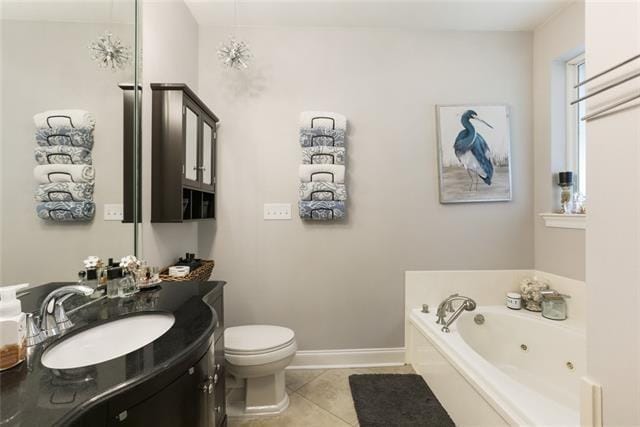 bathroom with toilet, vanity, a bathtub, and tile patterned floors