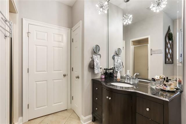 bathroom with vanity, tile patterned floors, and an inviting chandelier