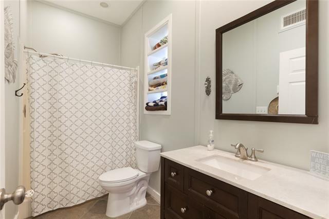 bathroom featuring tile patterned floors, vanity, and toilet