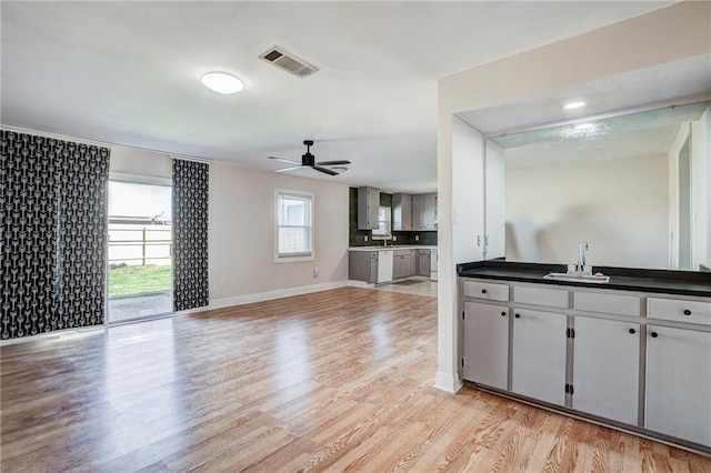 kitchen with sink, white dishwasher, light wood-type flooring, and ceiling fan