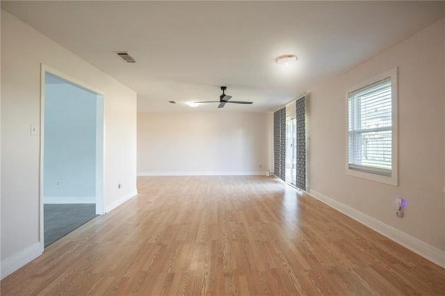 empty room featuring ceiling fan and light hardwood / wood-style floors