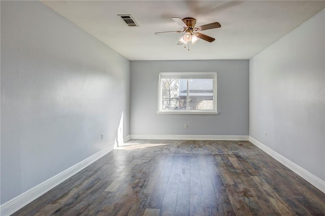 empty room with ceiling fan and dark hardwood / wood-style floors