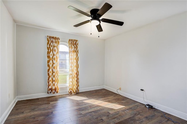 empty room with ceiling fan and dark hardwood / wood-style floors