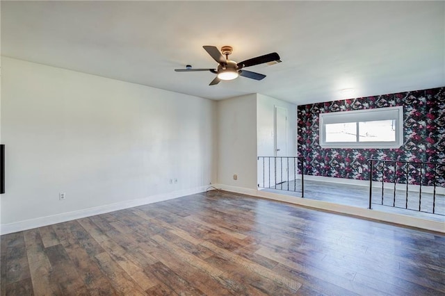 empty room with ceiling fan and hardwood / wood-style floors