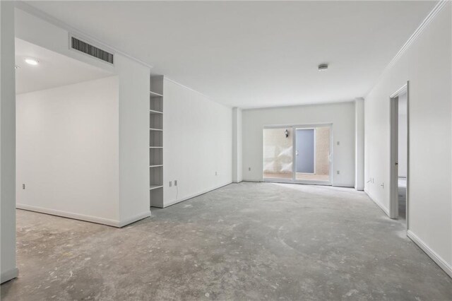 unfurnished living room featuring concrete flooring