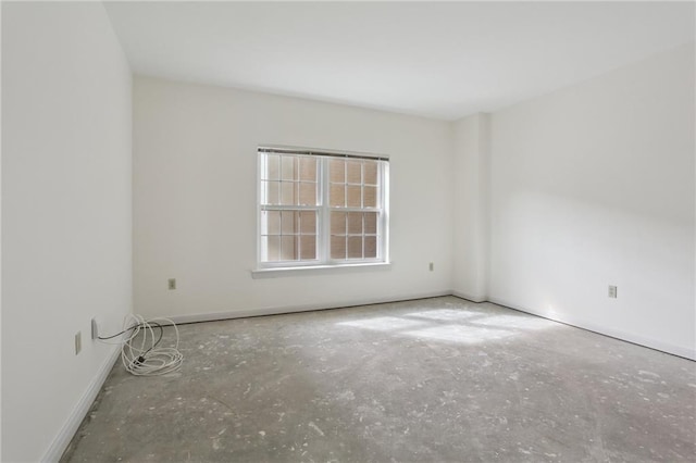 unfurnished room featuring concrete flooring