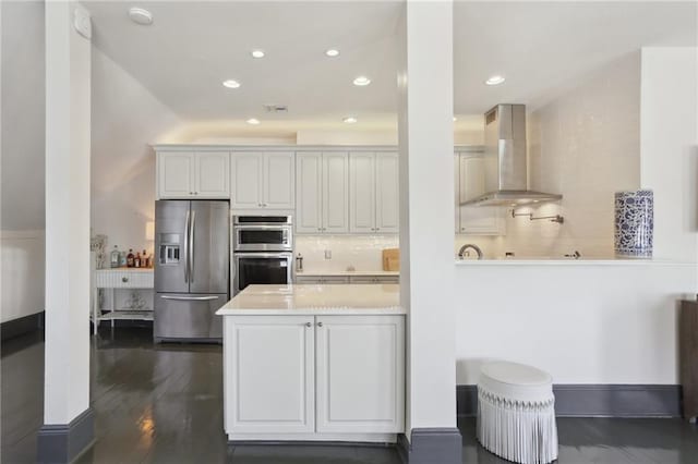 kitchen with exhaust hood, stainless steel appliances, kitchen peninsula, white cabinetry, and backsplash