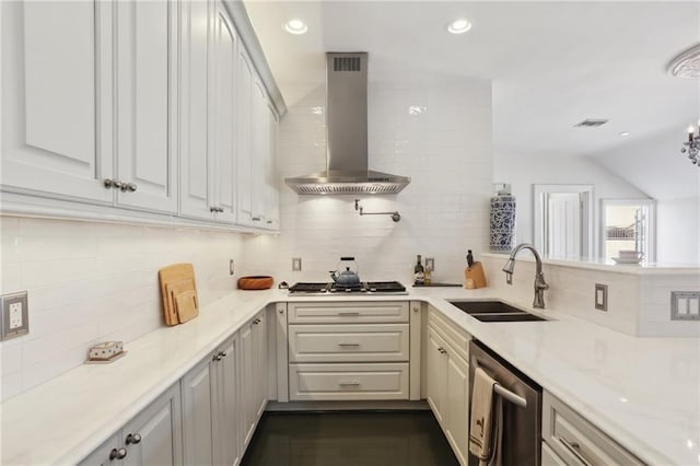 kitchen featuring sink, stainless steel appliances, white cabinetry, light stone countertops, and wall chimney range hood