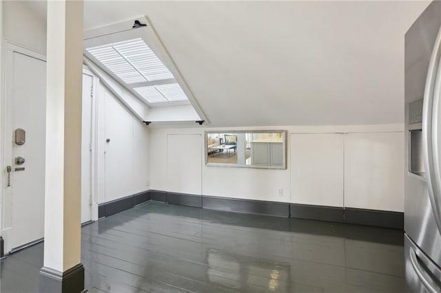 bonus room with lofted ceiling with skylight