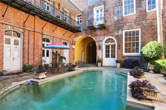 view of swimming pool featuring a patio and area for grilling