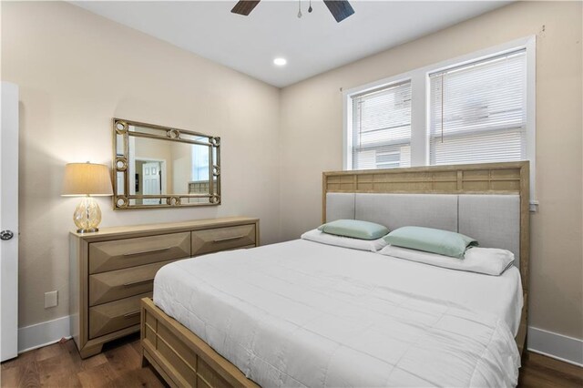 bedroom featuring ceiling fan and dark hardwood / wood-style floors