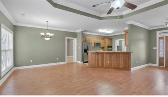 kitchen featuring stainless steel appliances, crown molding, a notable chandelier, and hanging light fixtures