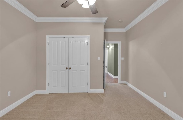 unfurnished bedroom with a closet, light carpet, ceiling fan, and ornamental molding