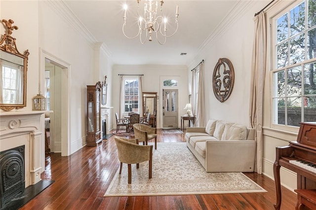 living room with dark wood-type flooring, ornamental molding, and a chandelier