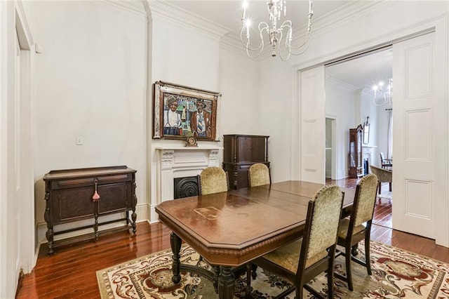 dining space featuring a notable chandelier, dark wood-type flooring, and ornamental molding