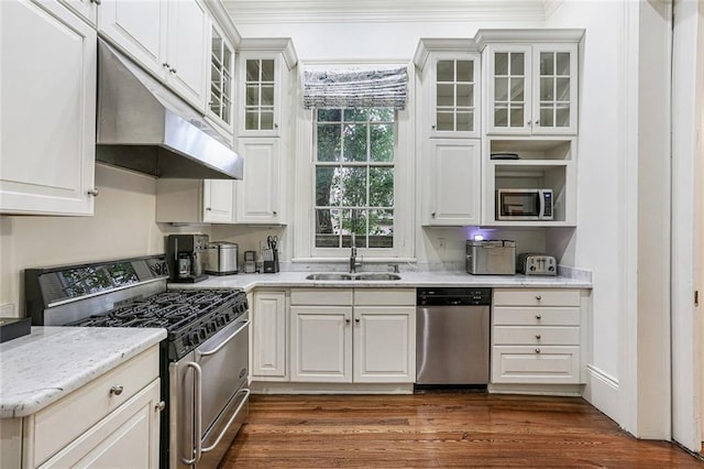 kitchen featuring stainless steel appliances, light stone countertops, sink, and white cabinets