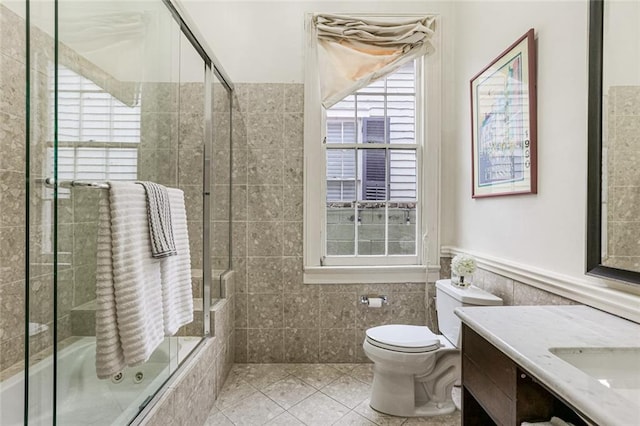 full bathroom with tile patterned flooring, vanity, enclosed tub / shower combo, and toilet