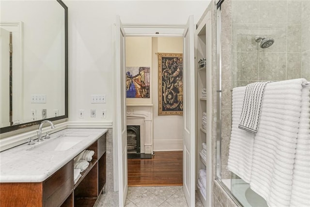 bathroom with vanity, tile patterned floors, and enclosed tub / shower combo