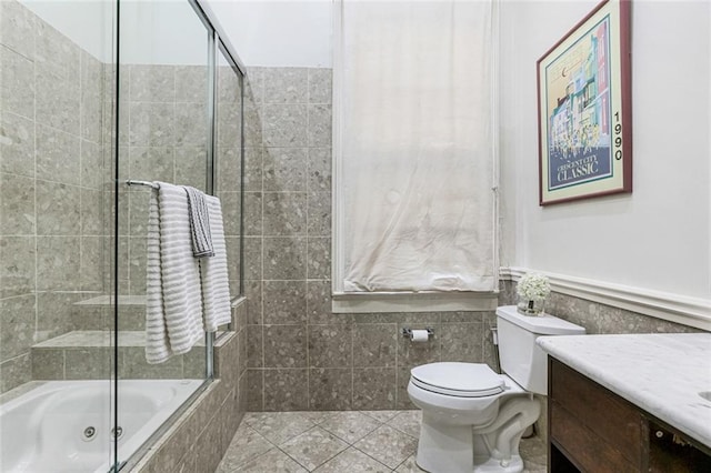 full bathroom with vanity, tile patterned flooring, bath / shower combo with glass door, and toilet