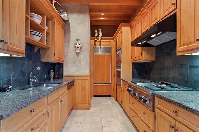 kitchen featuring sink, dark stone countertops, light tile patterned floors, decorative backsplash, and appliances with stainless steel finishes