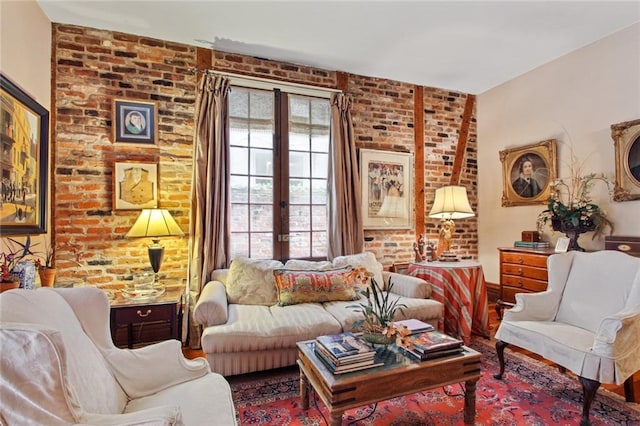 living room featuring brick wall and french doors