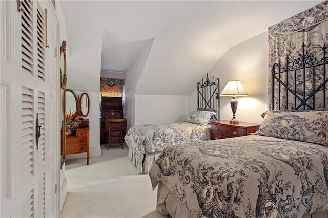 bedroom with lofted ceiling and light colored carpet