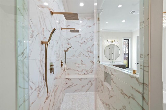 bathroom with tile walls, a tile shower, and crown molding