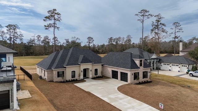 french country inspired facade with a garage and central AC