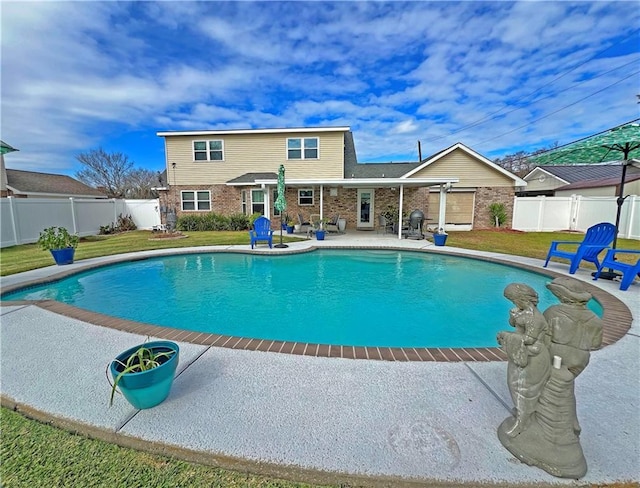 view of swimming pool featuring a lawn and a patio