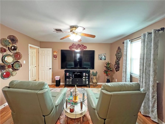 living room featuring ceiling fan and hardwood / wood-style floors