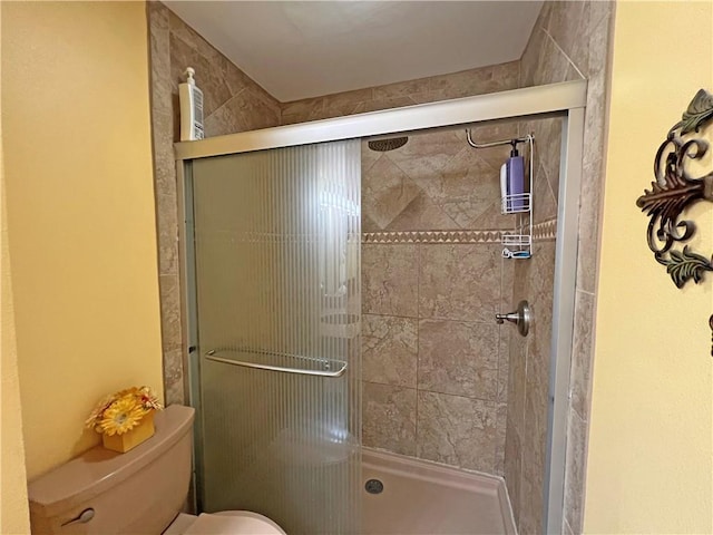 bathroom featuring an enclosed shower and toilet