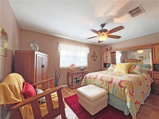 bedroom with hardwood / wood-style floors and ceiling fan