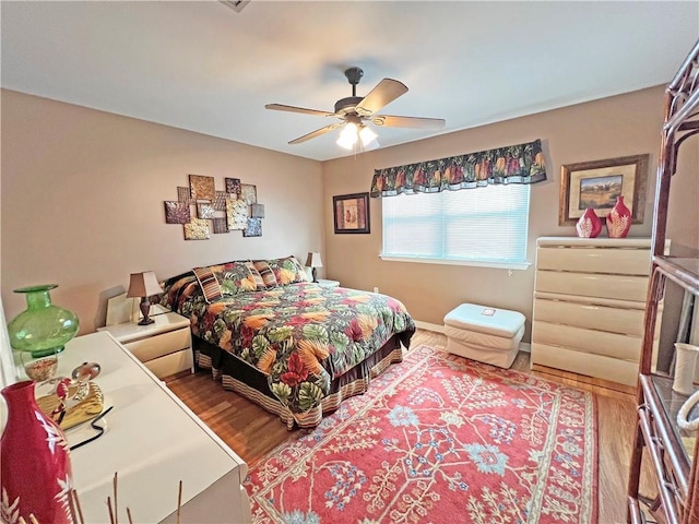 bedroom with ceiling fan and hardwood / wood-style floors