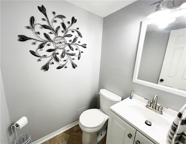 bathroom with toilet, tile patterned flooring, and vanity