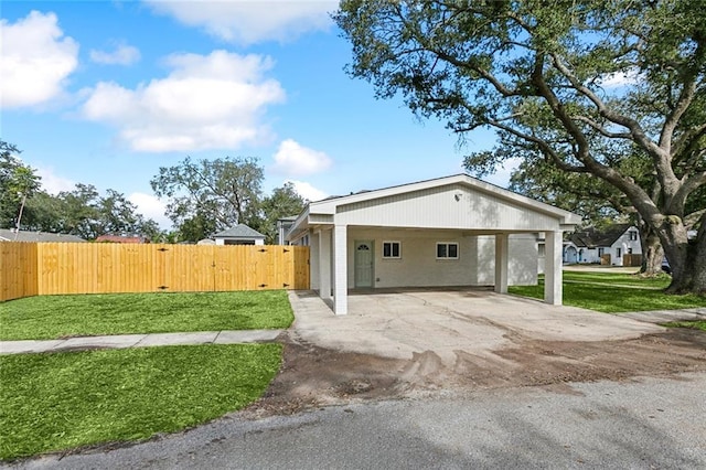 view of property exterior with a lawn and a carport