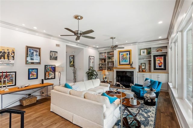 112 Bayou Perez Dr, Madisonville, LA 70447 - living room featuring ornamental molding, ceiling fan, wood finished floors, a fireplace, and recessed lighting