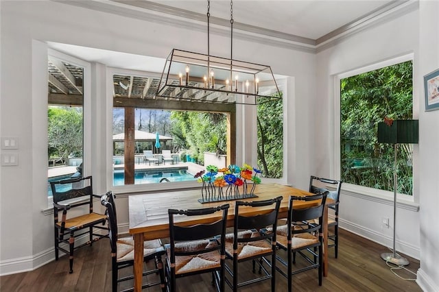 112 Bayou Perez Dr, Madisonville, LA 70447 - dining room featuring baseboards, ornamental molding, healthy amount of natural light, dark wood-style floors, and a chandelier