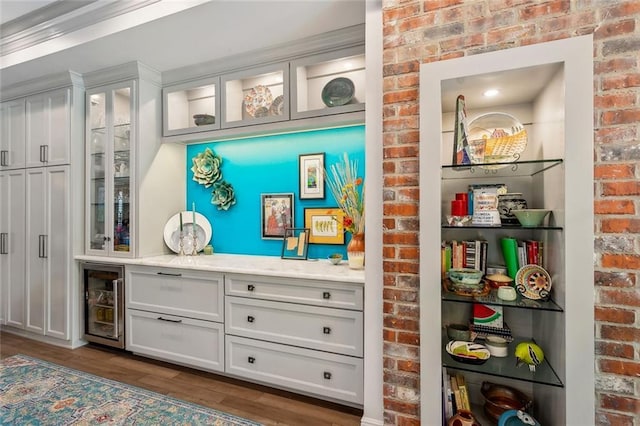 112 Bayou Perez Dr, Madisonville, LA 70447 - indoor dry bar featuring wine cooler, brick wall, and dark wood finished floors