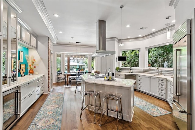 112 Bayou Perez Dr, Madisonville, LA 70447 - kitchen featuring stainless steel built in fridge, beverage cooler, crown molding, island range hood, and a kitchen island