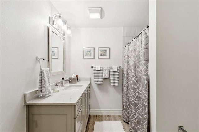 112 Bayou Perez Dr, Madisonville, LA 70447 - bathroom featuring vanity, wood finished floors, baseboards, and a shower with curtain