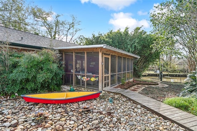 112 Bayou Perez Dr, Madisonville, LA 70447 - back of house with a sunroom and roof with shingles