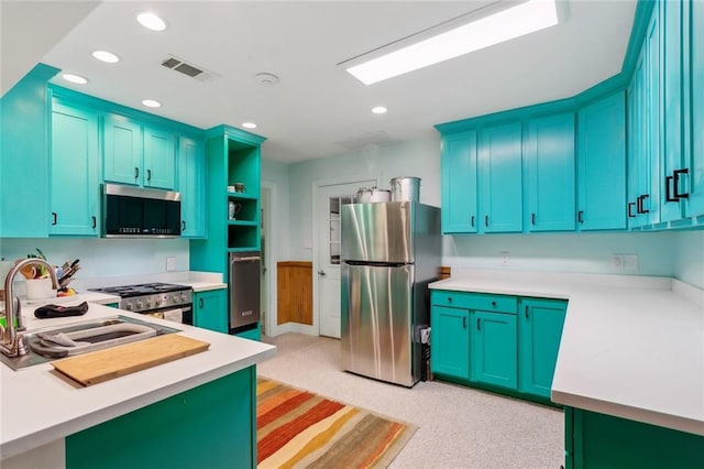 112 Bayou Perez Dr, Madisonville, LA 70447 - kitchen with appliances with stainless steel finishes, a sink, open shelves, light countertops, and light carpet