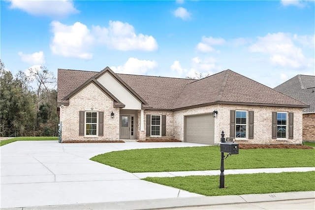 view of front of house with a front yard and a garage